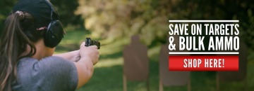 Woman firing at a shooting range with ammo and targets